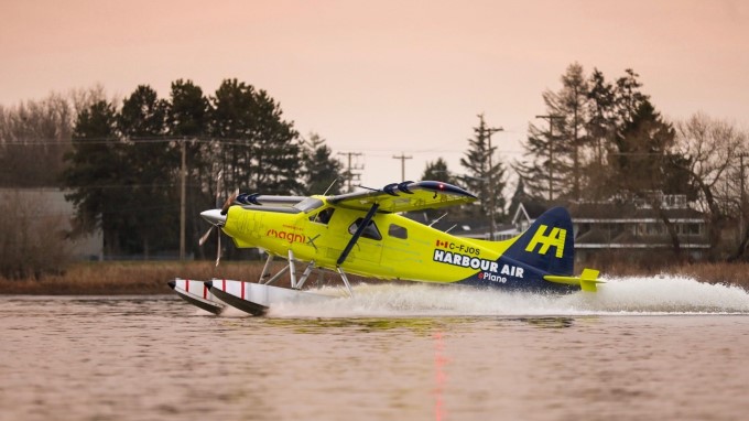 a yellow seaplane gliding on the water