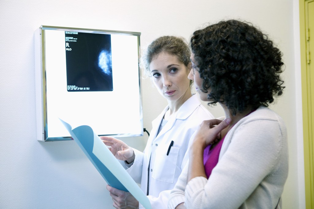 A female doctor going over mammography results with a patient.