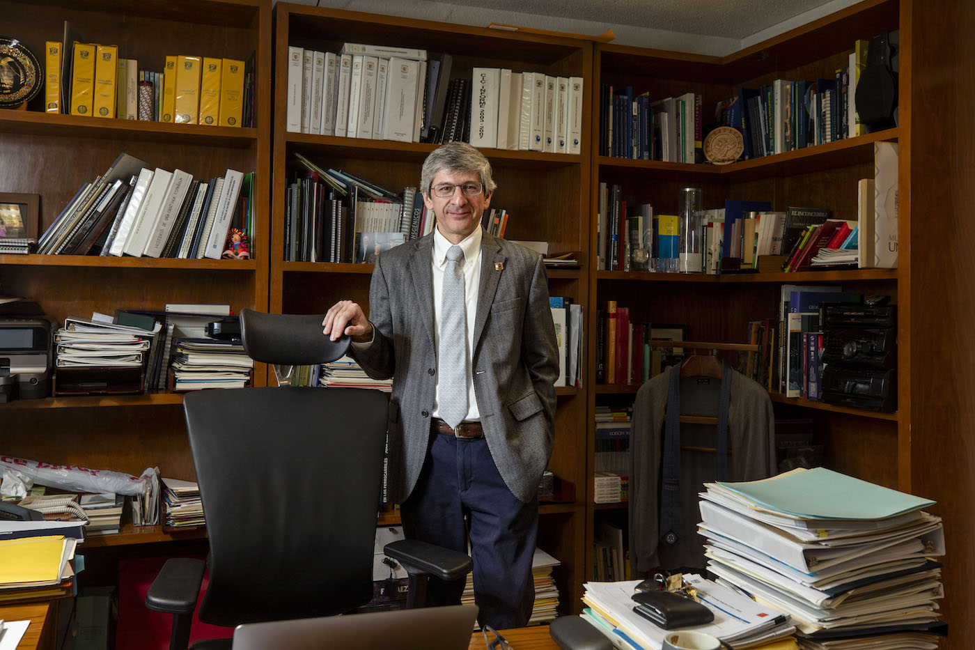 A man standing in an academic office.