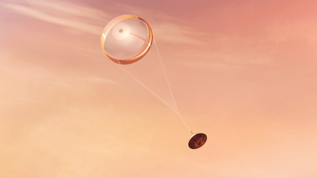 A round orange parachute extends from a metal space capsule as it falls diagonally across a pink sky.