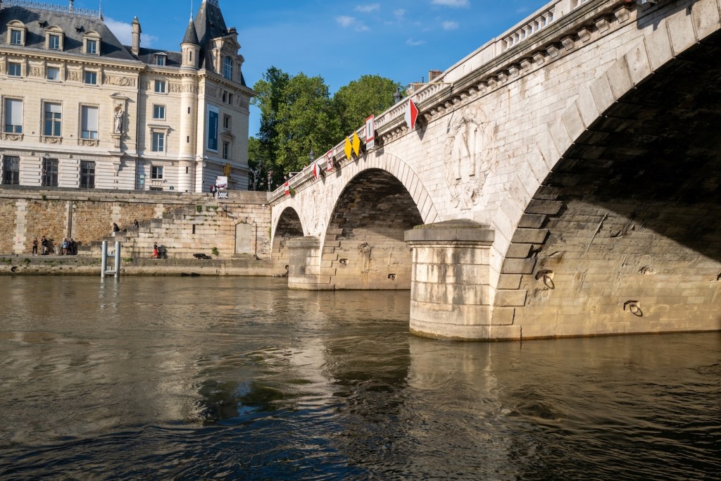 Murky water below a dirty bridge in Paris