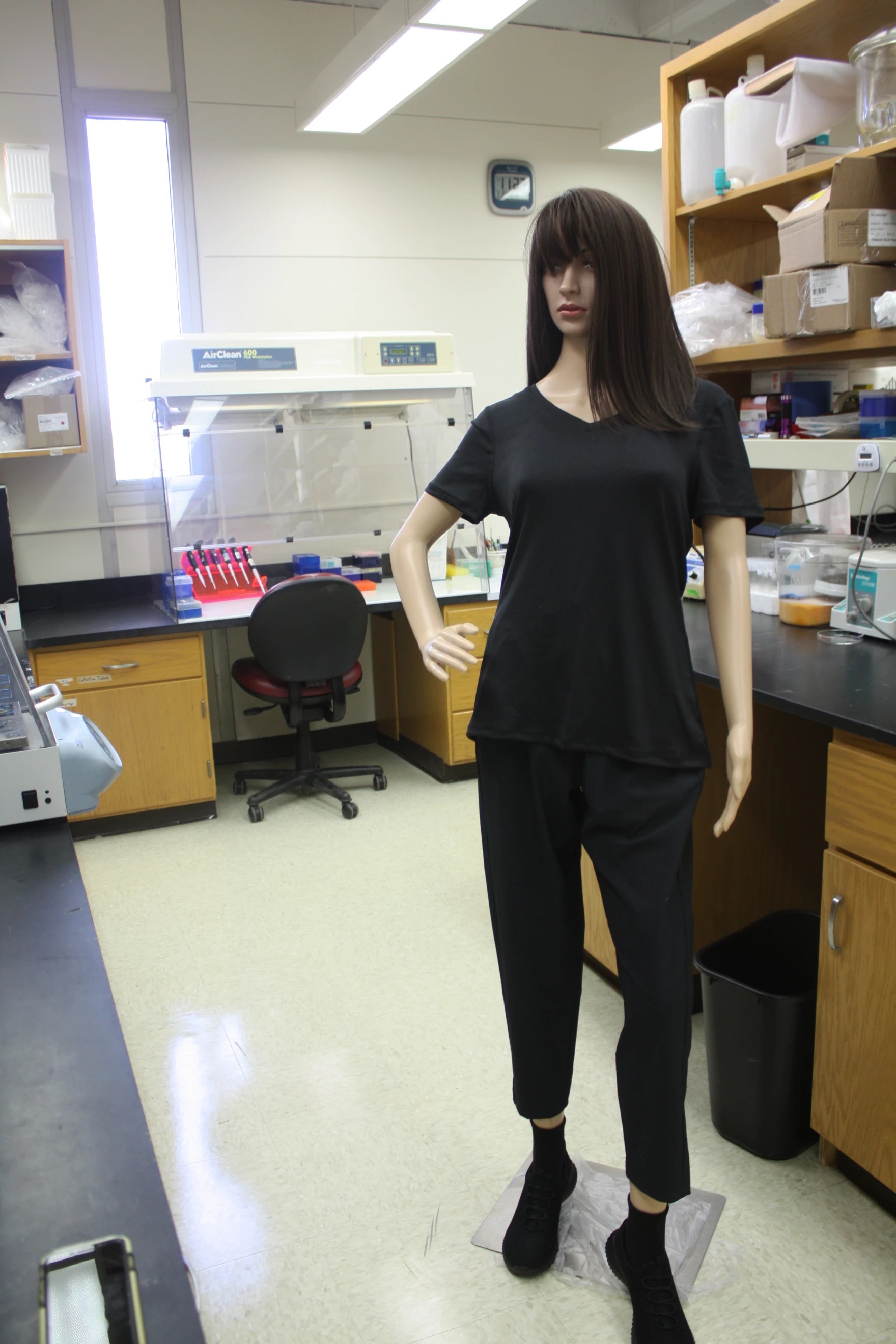 A mannequin wearing scrubs and a brunette wig