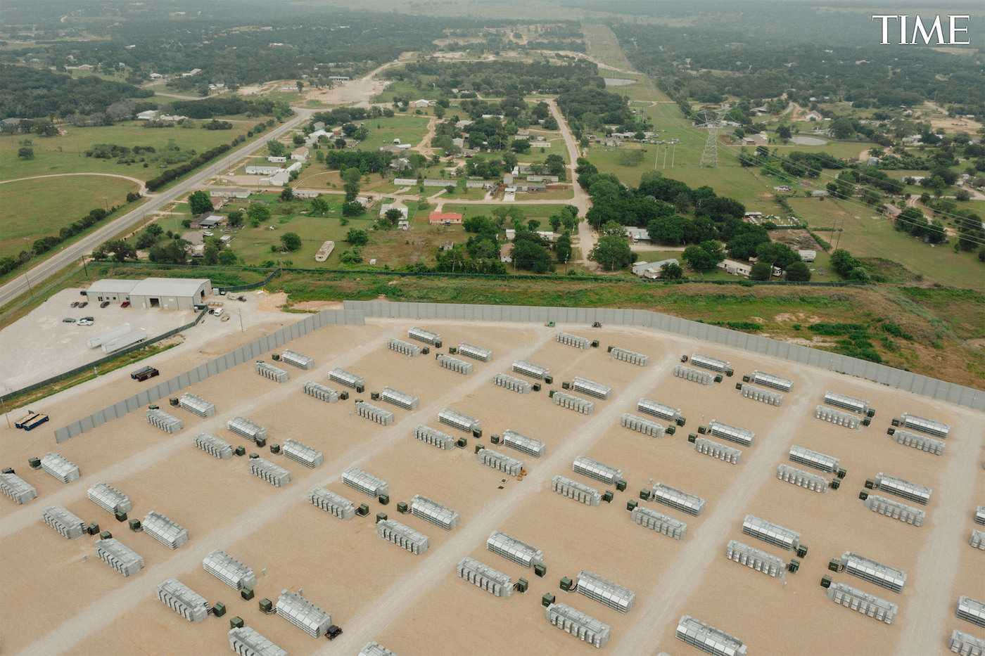 An aerial view of a group of buildings next to a residential area.