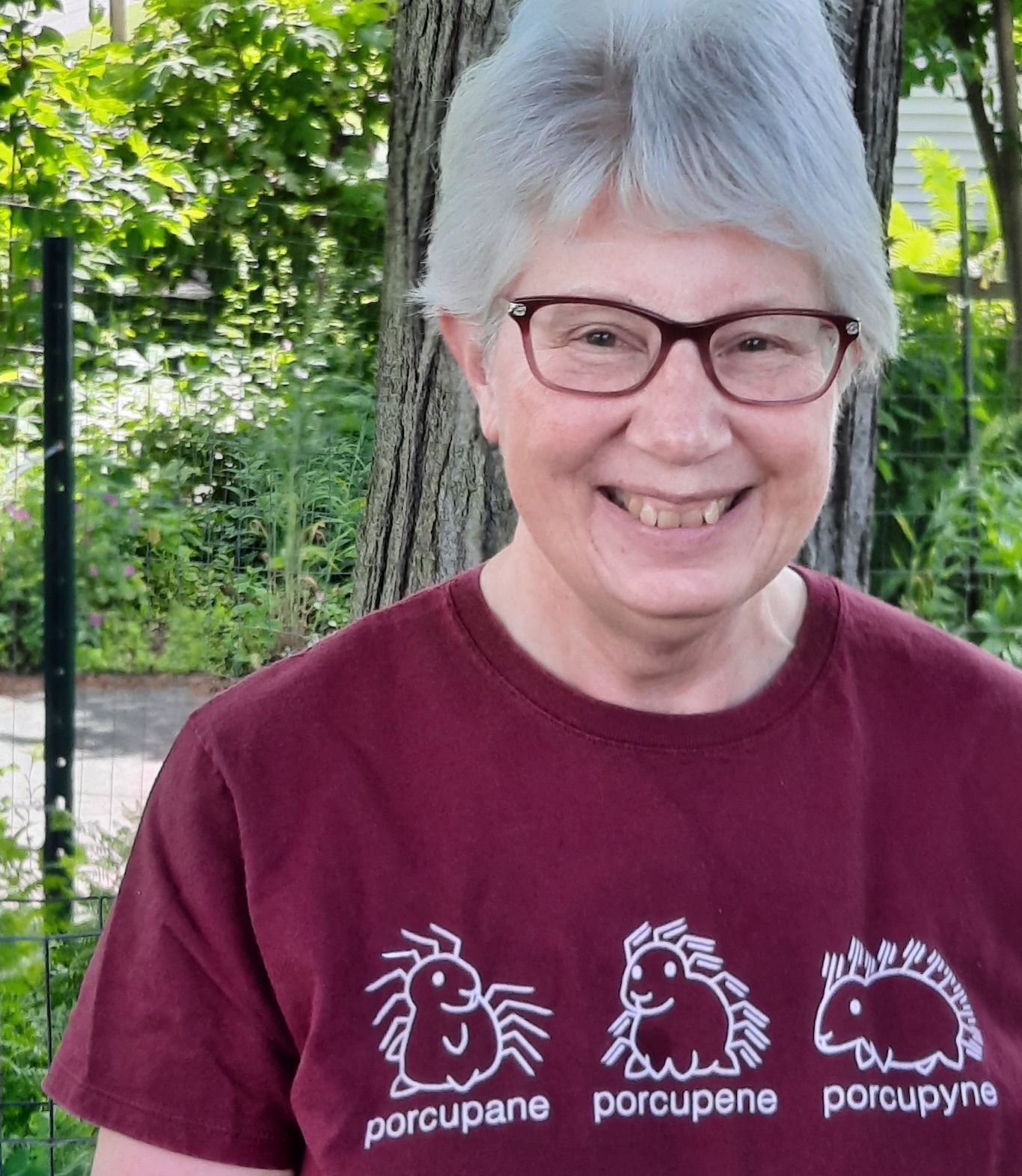 A woman wearing glasses outside.