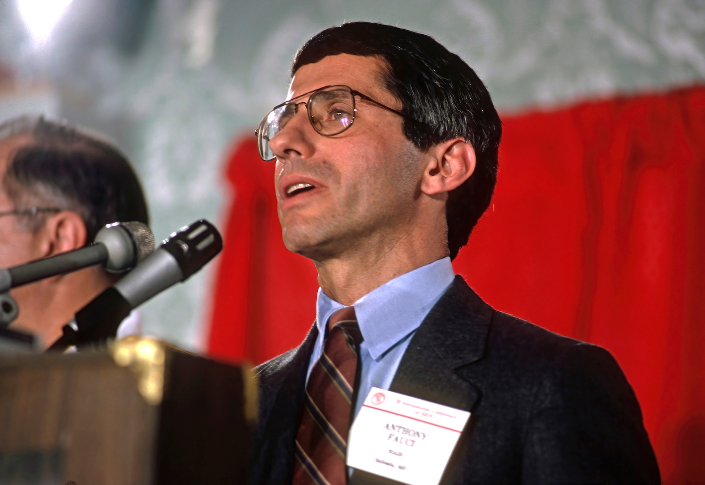 A man speaking into a microphone at a conference