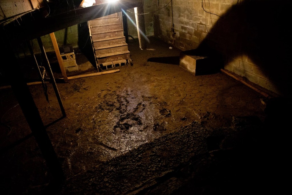 A basement floor covered in sewage.