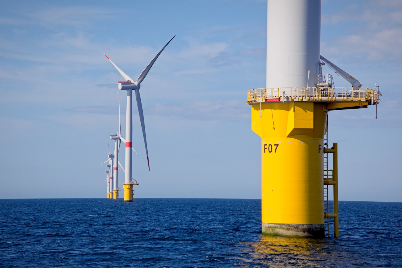 Fixed offshore wind farm in Europe. Wind turbines sticking out of the ocean