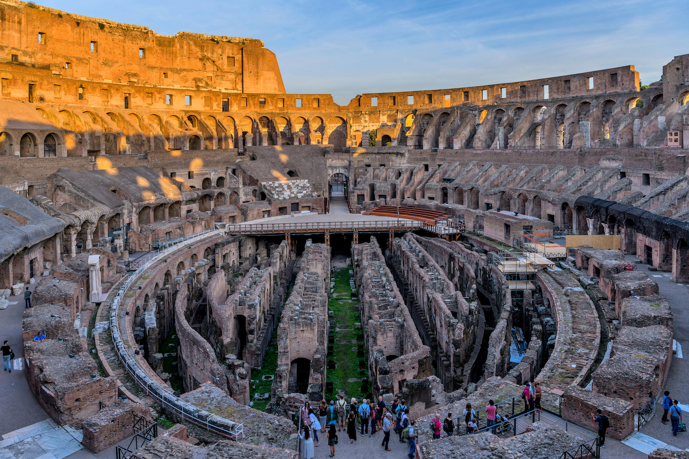 Rome, Italy - October 3, 2018: A wide-angle sunset overview of the arena and hypogeum surrounded by ancient high walls at inside of the Colosseum.