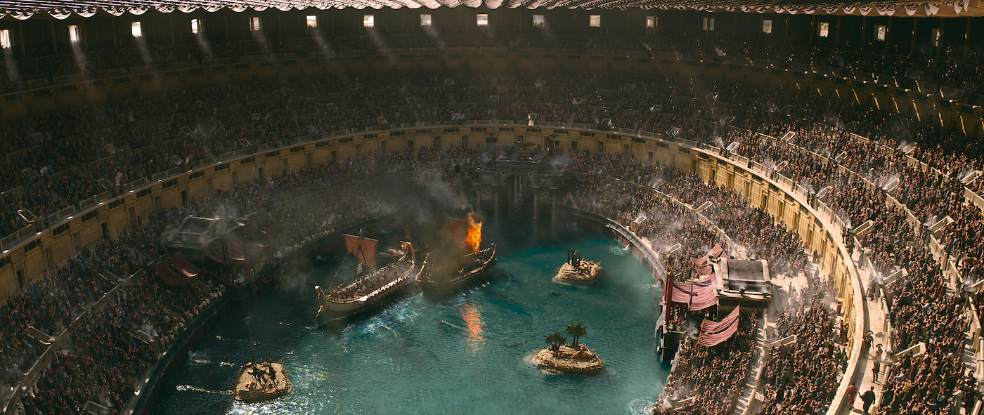 A movie set of the Colosseum made to look like its center is filled with water.