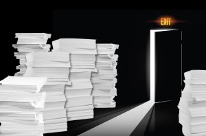 an exit door surrounded by stacks of paper