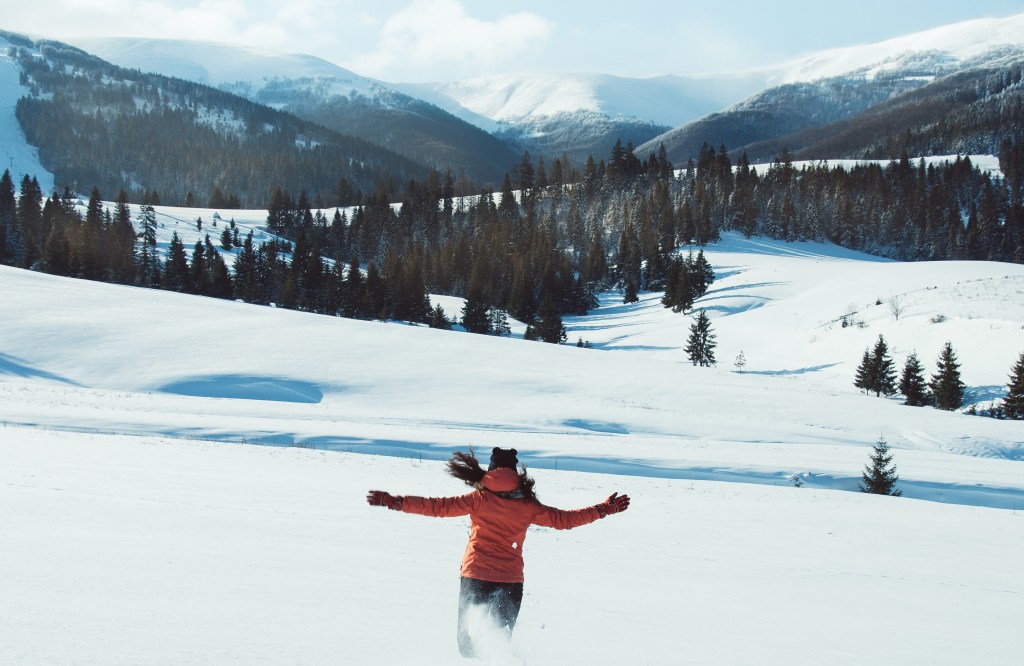 A person running on a snowy mountain