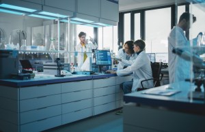 Modern Medicine Research Laboratory: Diverse Team of Multi-Ethnic Young Scientists Analysing Test Samples. Advanced Lab with High-Tech Equipment, Microbiology Researchers Design, Develop Drugs