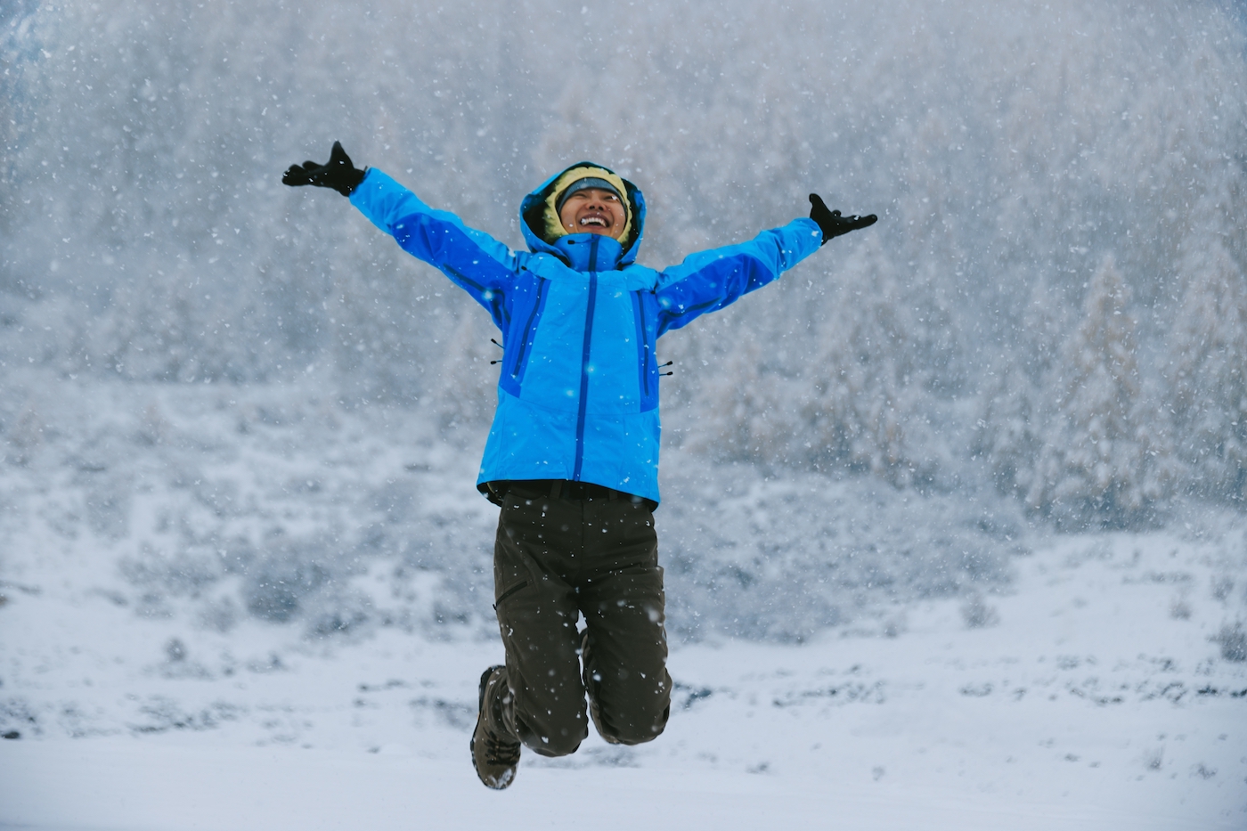 woman jumping in a beautiful snowing landscape